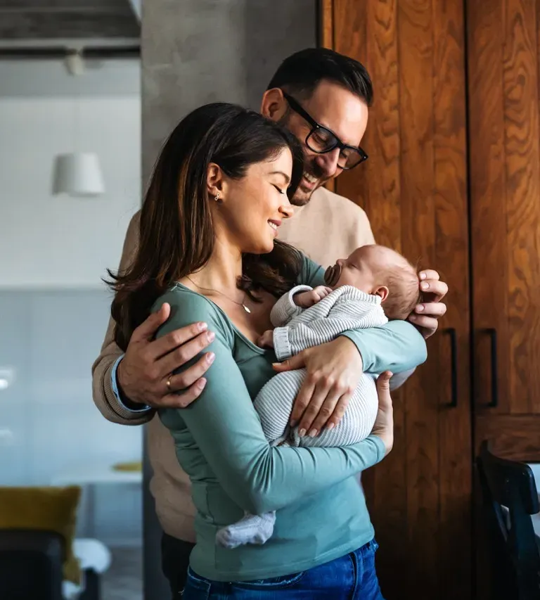 Happy family playing outdoors, parents with child in nature